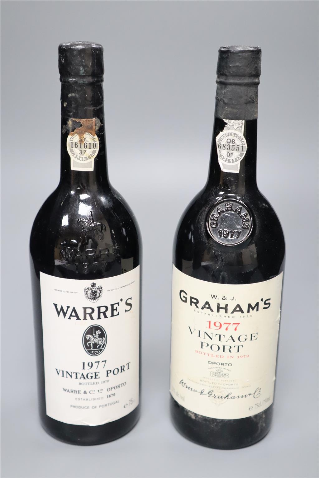 Two bottles of vintage port; Warres 1977 and Grahams 1977